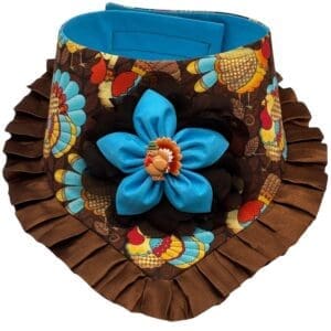 Colorful turkey-themed neck accessory with blue flower.