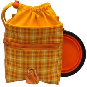 Plaid drawstring bag with portable orange bowl.