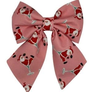 Pink bow with Santa print, festive design accessory.