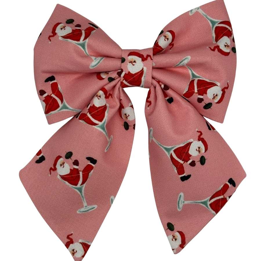Pink bow with Santa print, festive design accessory.