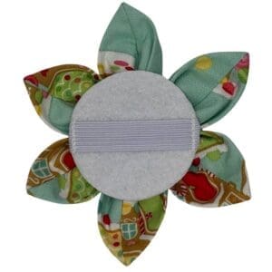 Holiday-themed fabric flower hair accessory back view.