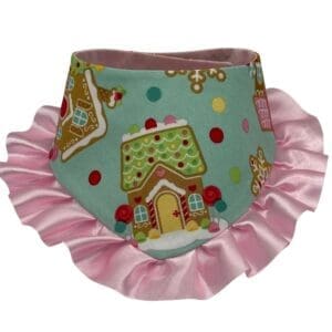 Gingerbread-themed dog bandana with pink ruffled edges.