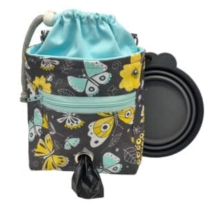 Butterfly print dog treat bag with dispenser and bowl.